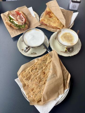 An assortment of cappuccinos and pastries on a table