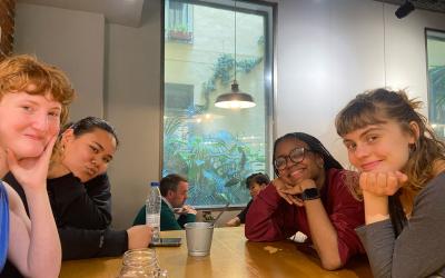 Four students sitting at a dinner table in Spain